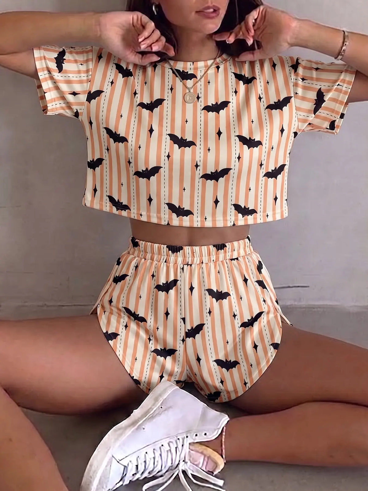 Halloween Summer Women's 2-Piece Set with Pumpkin Ghost Print: Casual Loose Knit Short-Sleeve Top with Midriff Reveal and Side-Slit Shorts; Stylish loungewear, suitable for everyday wear, parties, and other occasions.
